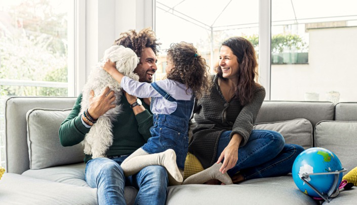 Family Laughing on Couch