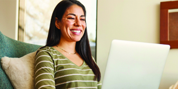 Woman Smiling Looking at Computer